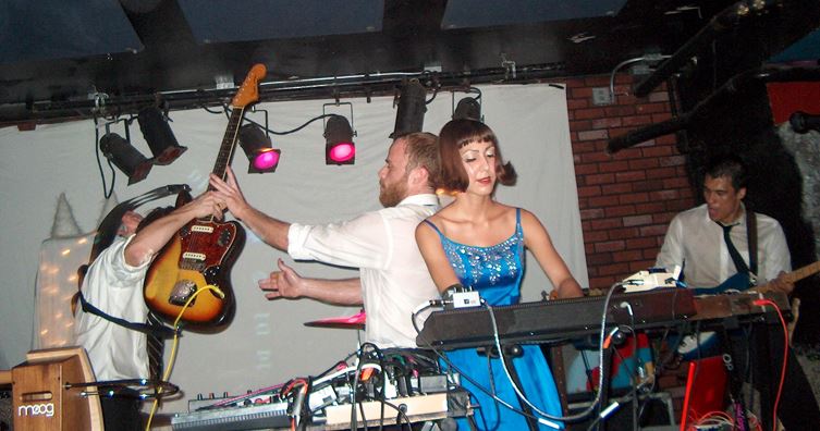 Ryan Figg and Josh Lambert exchange guitars during a song in San Francisco, August 2008