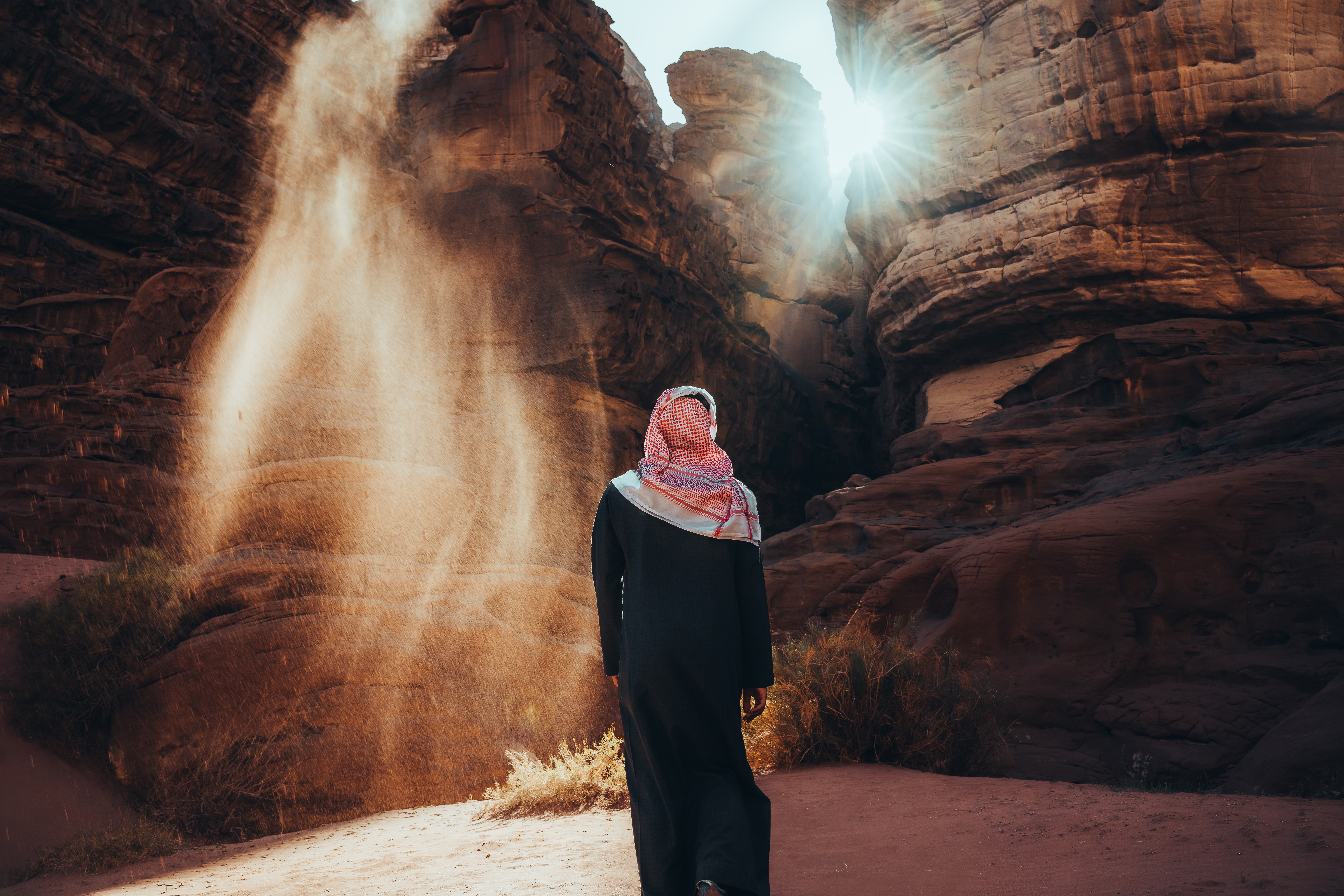 A woman standing in front of a rock formation