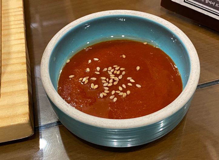 Gochujang with sesame seeds and olive oil in a bowl