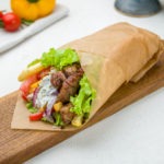 Gyros with beef on the board on white concrete table Greek cuisine