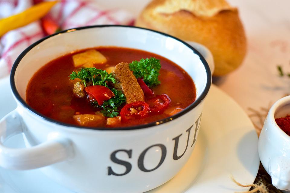 a soup on a white bowl with the word soup