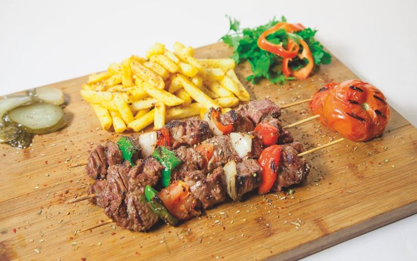pork bbq, fries, tomatoes on a chopping board