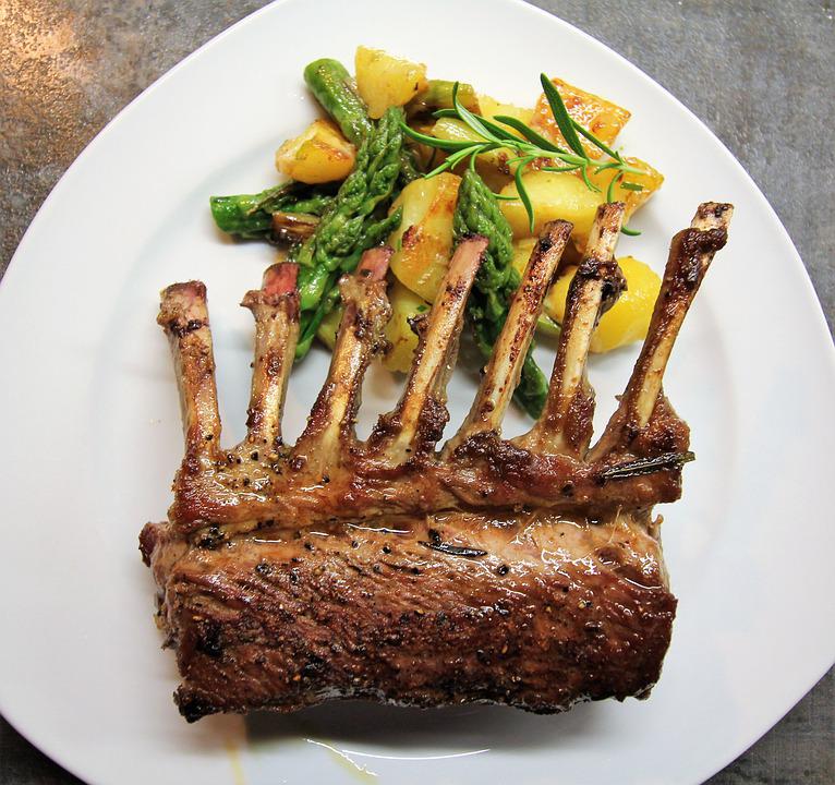roasted lamb, asparagus, and potatoes on a plate